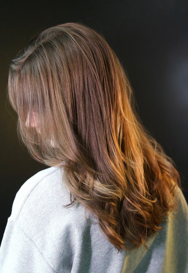 Side and back view of long hair showing the flow of lived-in layers and dimensional warm tones.